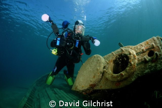 Diver/photographer poses at the engine of the steam tug '... by David Gilchrist 