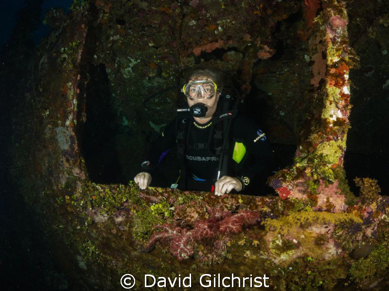 Diver exits Truk Lagoon wreck. by David Gilchrist 