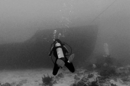 Diver approaching the bow of a wreck in Aruba. Nikonos V,... by Matthew Shanley 