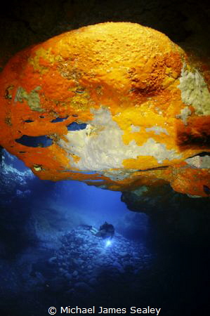 Diver in a volcanic cave by Michael James Sealey 