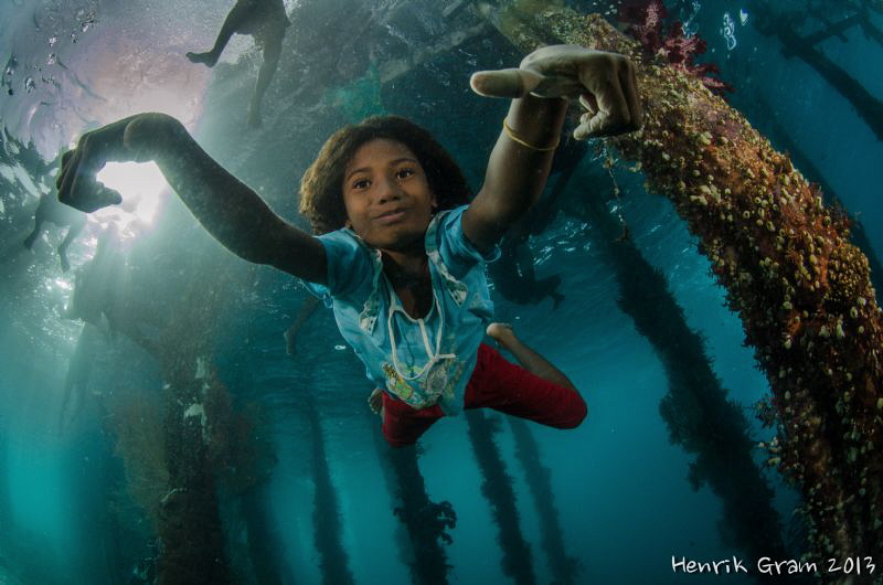 Papuan Girl Posing under Aborek Jetty by Henrik Gram Rasmussen 