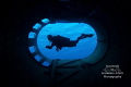 “Smokestack Silhouette” - A diver is framed within the smokestack on the Kittiwake shipwreck. 