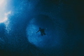 Vortex.
Freediver floats amidst the baitfish of Swallows Cave, Tonga 