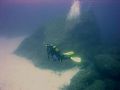 Diving off Cirkewwa reef, Malta,with 'sugar loaf'rock in the background. 