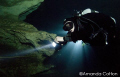 Cave diver next to the infamous "Big E" in Hole in the Wall at the Mill Pond in Marianna, Florida. Technical diving.

©Amanda Cotton 