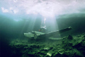 Diver with airplane under the ice at Morrison's Quarry. Nikonos V, 12mm Sea & Sea lens and Fuji film in natural light with manual exposure. Cropped for subject and colour corrected. 