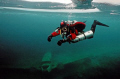 Tech diver under the ice in Morrison's Quarry, Quebec. Nikonos V, Nikonos 20mm lens, Kodak 400 ASA film, manual exposure with Ikelite 150 strobe fill. Yes, the plane is supposed to be there. 