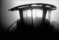 The sun bursts through the skeletal remains of the wheelhouse of the Keystorm, lost in the USA waters of the St Lawrence River not far from Rockport. Nikonos V Sea & Sea 12mm lens, 3200 ASA B&W film, manual exposure. 