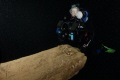 Diver poses at the broken bowsprit on the Tiller Wreck, Lake Ontario 