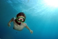 Young freediver descending 