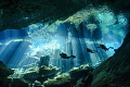 Divers enjoying the spectacular natural lighting display in Kukulkan