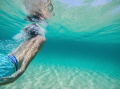 This photo is taken of my boyfriend diving under a wave. I absolutely love the colours in the background and the reflection of the sun through the water on his skin.