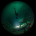 Diver scoots towards the blinding light