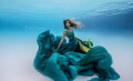 The model is a free diver who goes by the name @SaltSiren on Instagram. I shot this using a Canon 5D mark ii in an ikelite housing with a 14mm lens. Natural lighting and image was shot in the shade. Dress was designed by Annell Broeder @BrodieBird