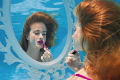 Getting Ready. Part of a collaborative underwater series based on getting ready for a night out. The model is sitting at a dressing table mirror putting on lipstick - underwater!