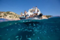 We had an amazing family day on a boat around Ibiza in the clearest water I have seen. There were so many fish swimming around the boat and I think this one captures the action above and below.