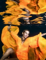 Photo of Rahiti wearing her Black Pearl creation, dress from designer Valerie Pache - First time modeling in the water for Rahiti who did very well.  Sub surface shot taken in the lagoon of Bora Bora at dusk.
