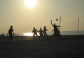 Young boys play volleyball with a makeshift 