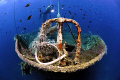 A popular wreck in the Aegean sea off the coast of Cesme .  The ship's name is MONEM. Me and buddy were the last ones off the wreck before the dive boat left.  I decided to snap one last shot off the bow with my buddy in the back ground...