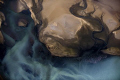 Aerial view from about 2000ft of the tide draining into the lagoon at Walvis bay, Namibia.  The small dots are flamingos to give a bit of scale.