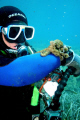 While diving off Corfu my dive buddy found this little octopus. The octopus decided to hitch a ride on his wrist, how surreal. I took this with a EOS 20d, format RAW, lighting single DS125 ikelite strobe on half power, 20mm prime canon lens f2.8 USM.