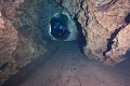 divers swimming along the tunnel of the Orange Grove Sink in Peacock State Park, FL