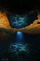 A RAY OF LIGHT. The sun has found it's way through the rock to illuminate this cave. The ray of light and reflections are natural light, I only used a flash to illuminate the caves ceiling.