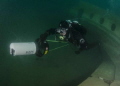 A diver with a scooter playing in a lake in England